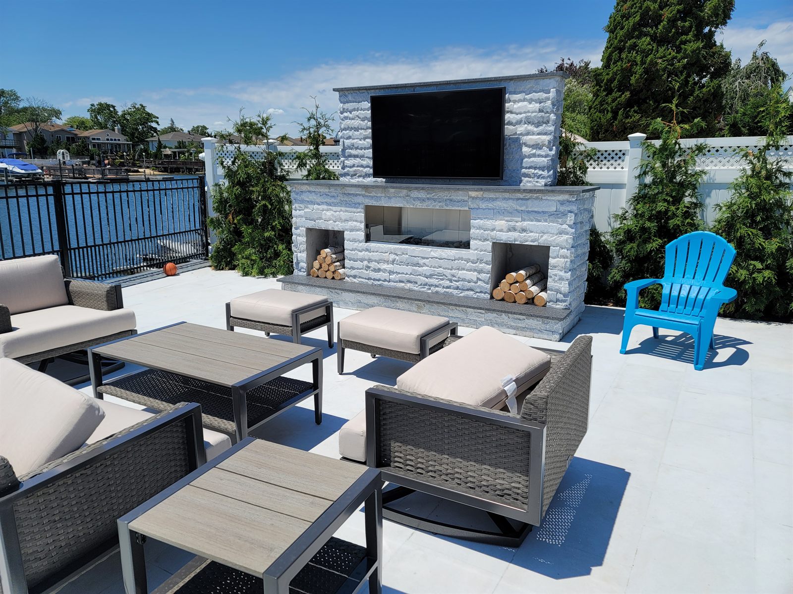Outdoor living space with a stone fireplace built by Level Line in Bellmore, NY